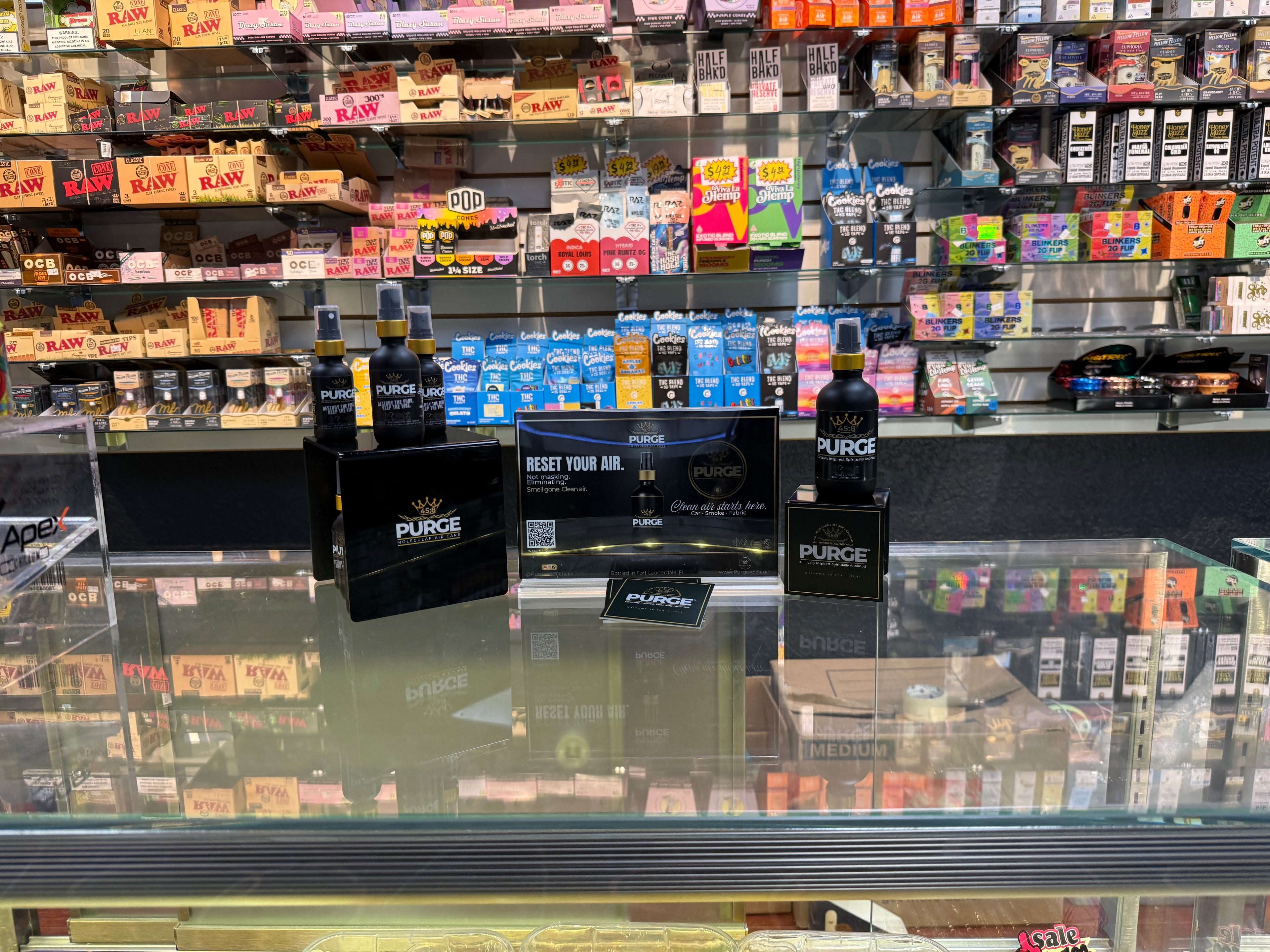 Display of Purge products in a store setting with various items in the background.